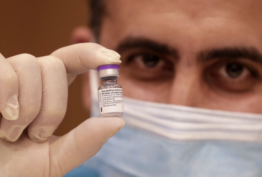 A medic prepares a dose of the COVID-19 Pfizer/BioNTech vaccine at Lebanon's American University Medical Center in the capital Beirut, on February 14, 2021, as the country kickstarts its inoculation campaign. Lebanon gave its first COVID-19 vaccine dose to a doctor, as it started inoculation it hopes will keep the pandemic in check amid a deepening economic crisis. / AFP / ANWAR AMRO